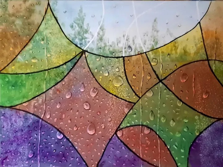 buntes Glasmosaik mit Wassertropfen gibt Blick auf Natur frei
